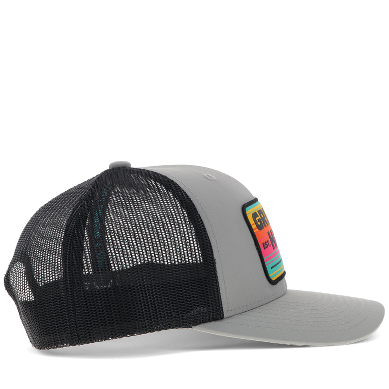 right side of black and grey Gruene Hall hat with pink, yellow, teal serape patch