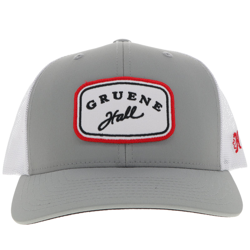 front of grey and white Gruene Hall x Hooey hat with red, black, white Gruene Hall rectangle patch