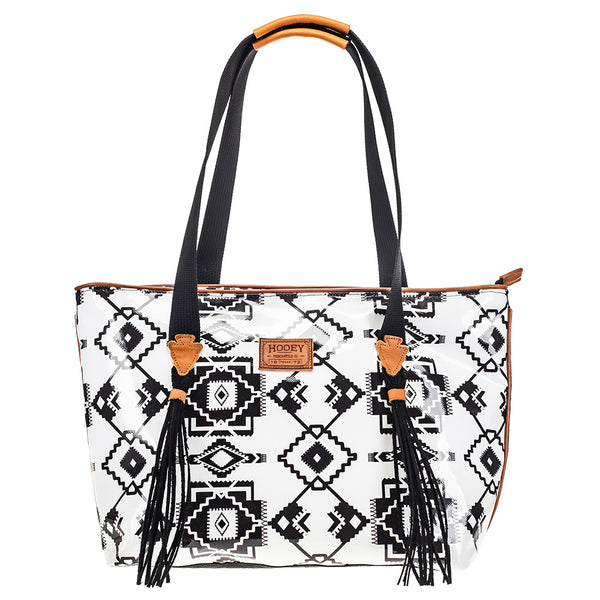 front of black and white Aztec pattern xl tote back with black strap and tassels and brown leather arrow heat details and handle details