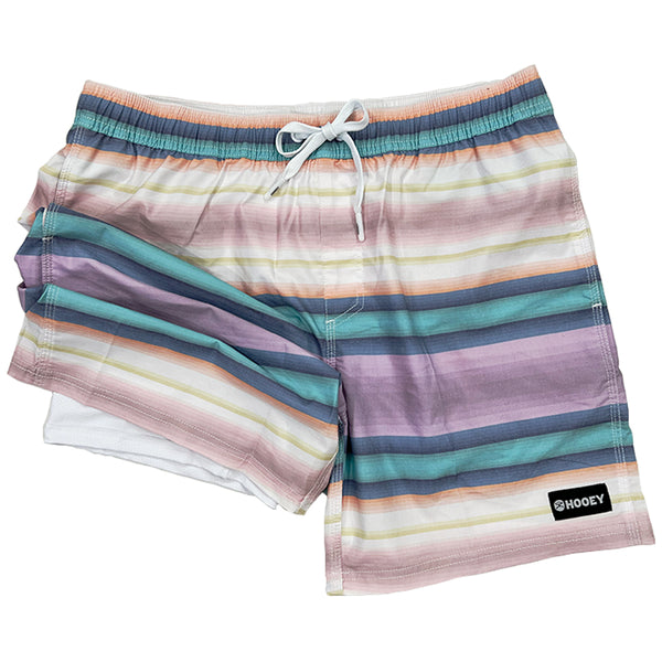 sunset serape board shorts with leg bunched up