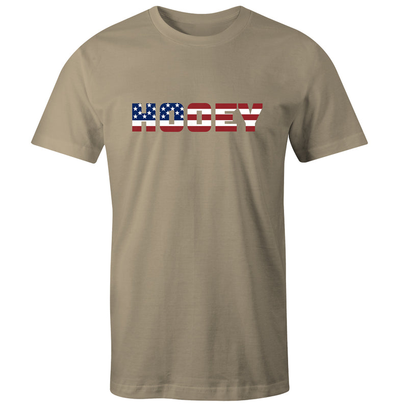 Patriot tee in tan with red, white, and blue logo