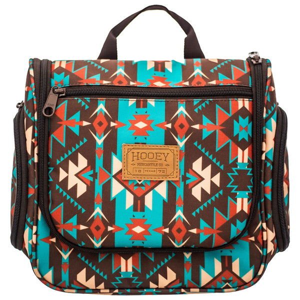 front of brown, teal, orange, white Aztec pattern travel bag with dark brown handle and zippers