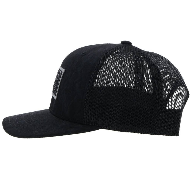 left side of the Doc black on black hat with white and black patch