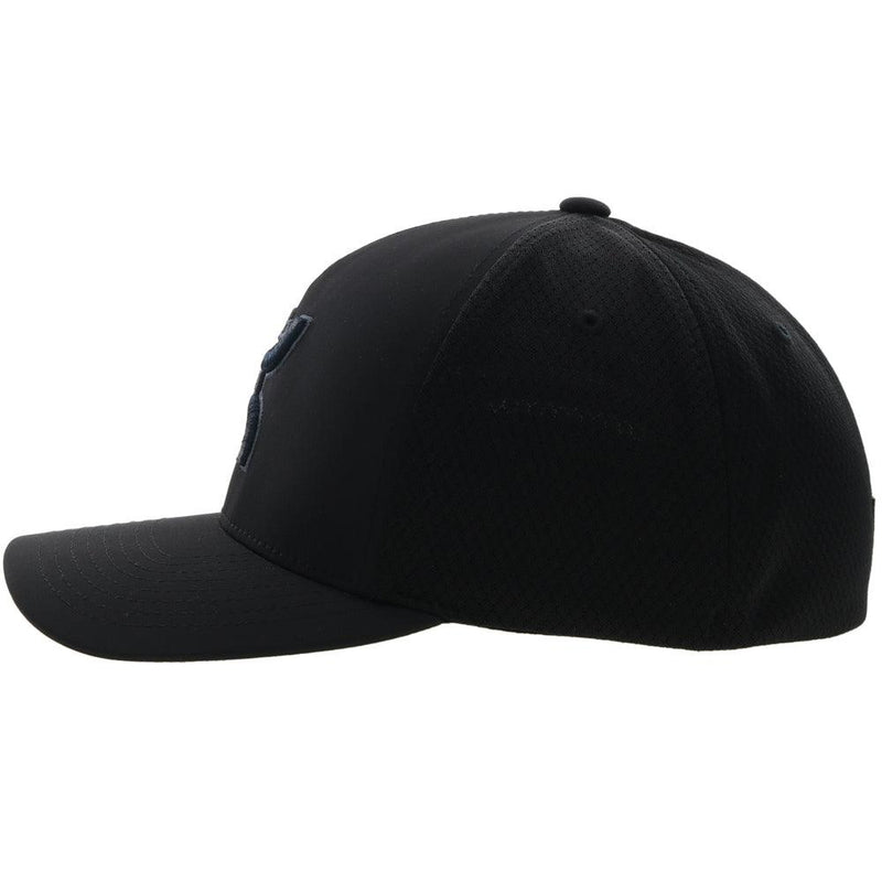 left side of the black on black Coach flexfit hat with charcoal logo