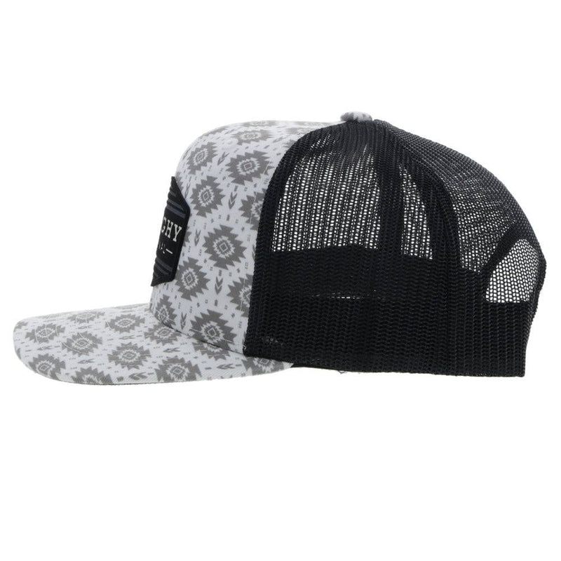 left side of the Youth Tribe hat in white and black with Aztec print and black patch