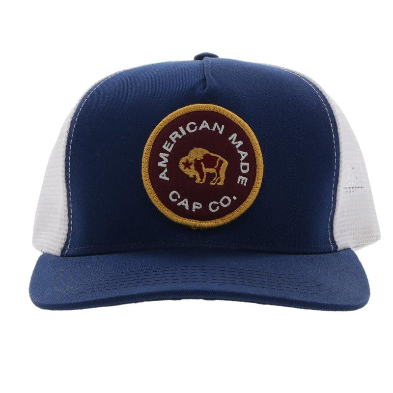 front view of the AMCC Navy and white hat with maroon and gold patch