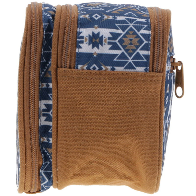 opposite side of the Dopp kit navy and white Aztec pattern and tan leather details