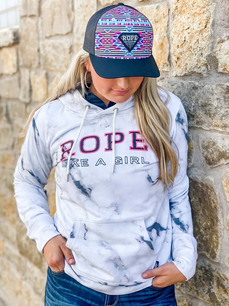 female model wearing the Rope Like A Girl white marble hoody with pink and black logo with jeans and RLAG hat