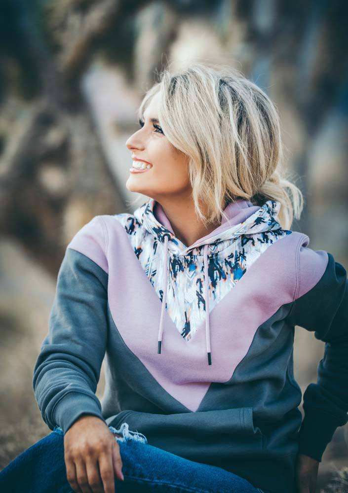 Lifestyle image of the Berkley Aztec, purple, and charcoal chevron pattern hoody on a female model