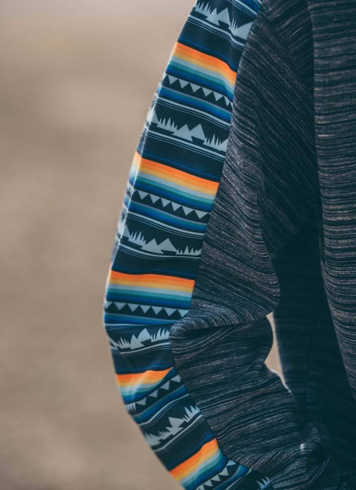 close up of the Canyon navy hoody with yellow, orange, light blue serape pattern sleeve