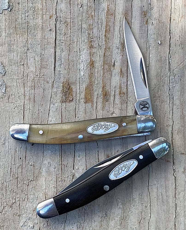 lifestyle image of the Ox horn slip joint brown and black knives