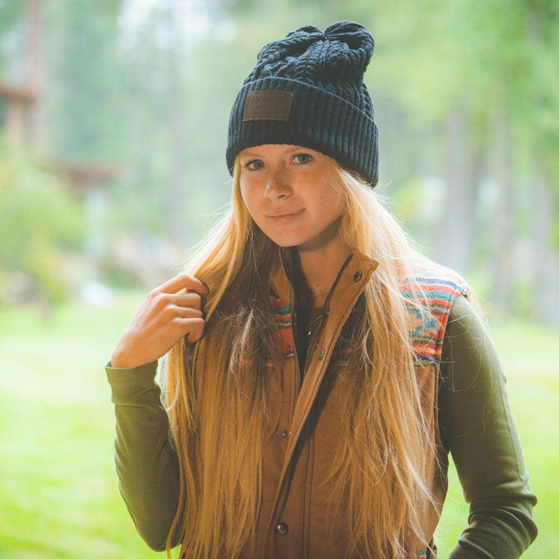 female model wearing black hooey beanie with leather patch on front